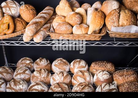 A assortment of different types of artisan bread displayed at a bakery Stock Photo