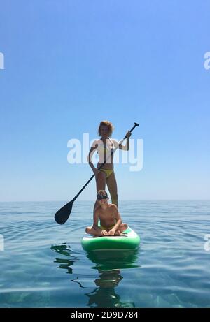 Sup board. water sport. a young woman stands on a board in the sea Stock Photo