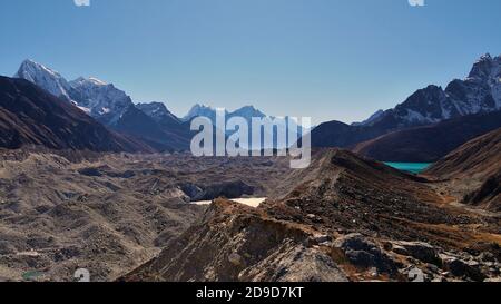 Stunning panorama view of Gokyo valley, Sagarmatha National Park, Khumbu, Nepal with majestic Ngozumpa glacier and the turquoise colored Gokyo lake. Stock Photo