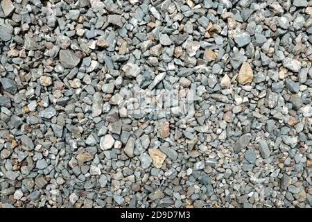 Gray gravel stone wallpaper background backdrop. Concrete rough grunge industrial texture pattern. Stock Photo