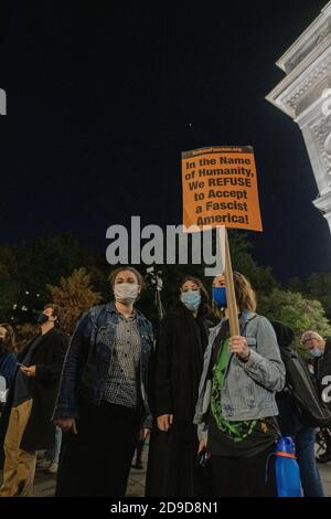 New York, New York, US. Nov 4th 2020. As the US awaits election results, a protester holds a sign denouncing fascism following an anti-Trump march through Greenwich Village Stock Photo