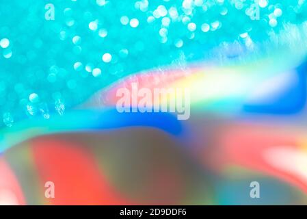 Abstract mixed holographic blue ai aqua blurred glitter shiny background. Liquid neon rainbow foil unicorn style. Bright sparkling bokeh style. Festiv Stock Photo