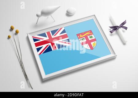 Fiji flag in wooden frame on table. White natural soft concept, national celebration theme. Stock Photo