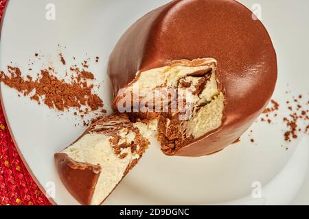 Mini cake luxury dessert covered with chocolate glaze on the table in cafe Stock Photo