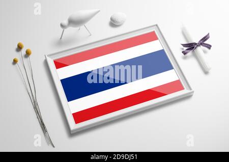 Thailand flag in wooden frame on table. White natural soft concept, national celebration theme.