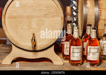 Front view of an oak barrel with a brass tap and sealed liquor bottles. The  drinks are prepared according to old classic recipes, copy space Stock  Photo - Alamy