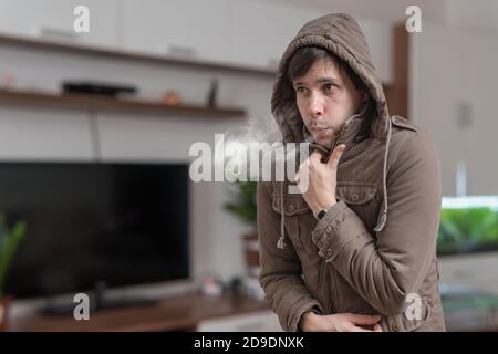 Young man feel cold at home. Stock Photo