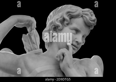 White angel of death against black background as a symbol of the end of life. Ancient statue. Religion, eternal life, immortality, faith concept Stock Photo