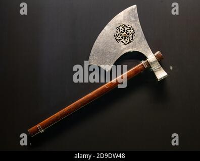 antique medieval old axe with wooden handle on black background Stock Photo