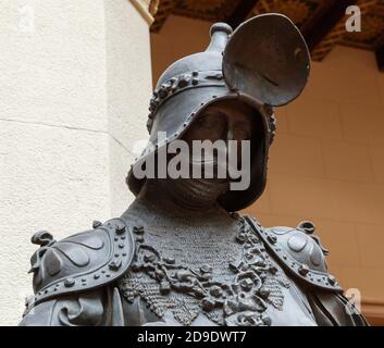 Sculpture of King Arthur old metal statue. Medieval knights armor