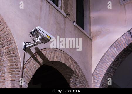 Professional observation cameras on a wall in the city at night Stock Photo