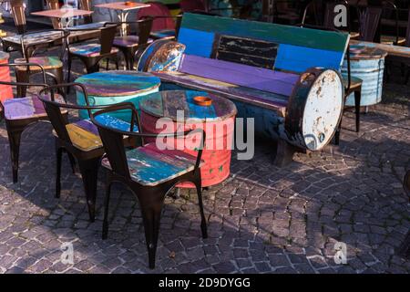 Unusual stylish tables with colorful empty chairs. Rainbow colors decoration Stock Photo