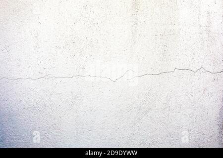 Surface of a wall with worn paint and cracks Stock Photo