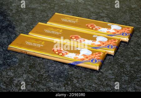 Three bars of Lindt Swiss Premium Chocolate. Milk Hazelnut. 300g Net. Stock Photo