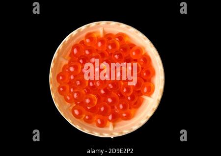 Red caviar tartlets isolated on a black background. Delicacy for Breakfast. Stock Photo