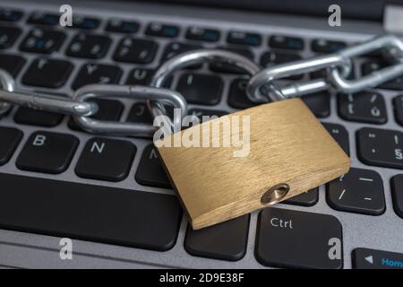 Lock with chain on computer keyboard. Data protection, privacy and security concept. Stock Photo