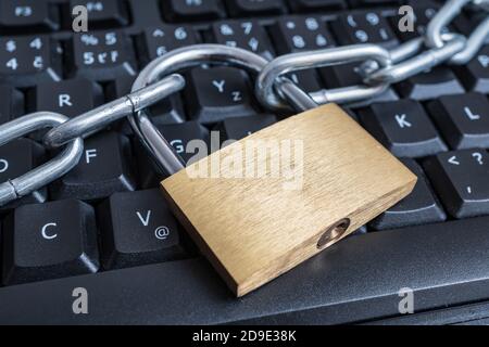 Data protection, privacy and security concept. Lock with chain on computer keyboard. Stock Photo