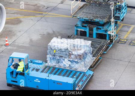 Schiphol, The Netherlands - January 16, 2020:  Loading of cargo on board of an airplane on Schiphol Airport, The Netherlands Stock Photo