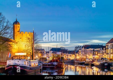 Evening view of a Dutch canal with sailing boats and stronghold tower in the city center of Zwolle Stock Photo