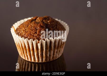 selective focus on a homemade cup cake muffin on glossy reflecting surface Stock Photo
