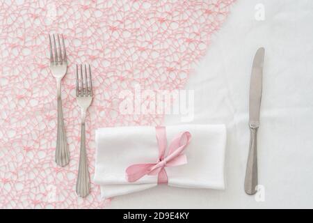 Festive table. Plates and cutlery with pink napkin on a white background. Table setting. background for menu, layout, recipe background, food flat lay. Stock Photo