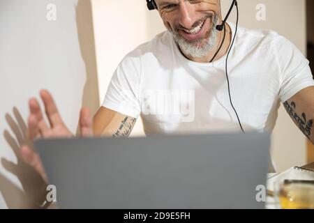 Male using a headset during a video conference Stock Photo