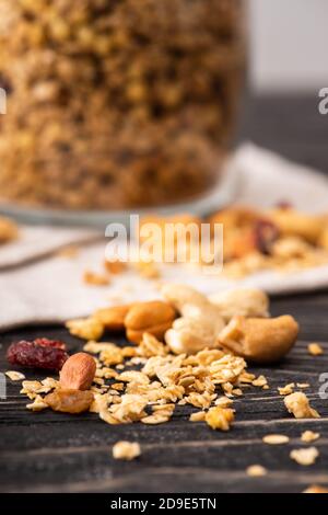 blurred delicious granola in glass gar on napkin and nuts Stock Photo