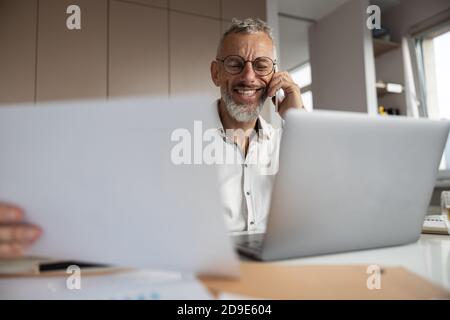 White-collar worker is discussing documents by phone Stock Photo