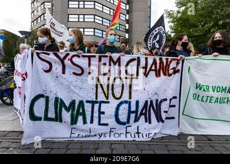 Gottingen, Germany. Autumn 2020. Fridays for future. Group of young women holding banner against climate change at demonstration. Stock Photo