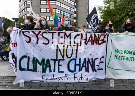 Gottingen, Germany. Autumn 2020. Fridays for future. Group of young women holding banner against climate change at demonstration. Stock Photo