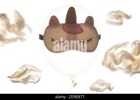 Balloon in a sleep mask among the clouds Stock Photo