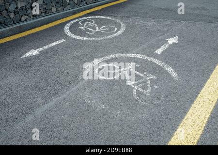 Bicycle lane. White road markup signal on concrete asphalt. Transportation restrictions on the way. No pedestrians allowed, no walking, riding bikes Stock Photo