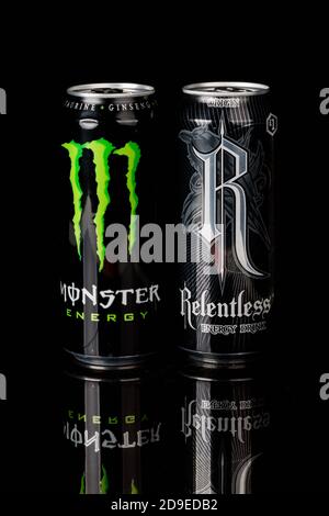 London, United Kingdom, 14th October 2020:- Cans of Monster &  Relentless Energy Drinks Isolated on a black background Stock Photo