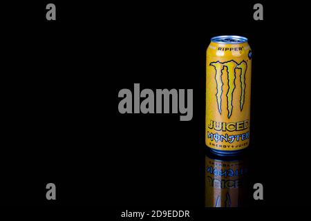 London, United Kingdom, 14th October 2020:- A can of Monster Ripper Energy Drink Isolated on a black background Stock Photo