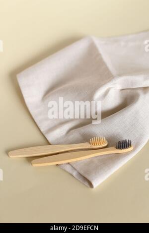 Two ecological wooden toothbrushes lying on white towel. Stock Photo