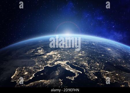 Planet Earth viewed from space with city lights in Europe. World with sunrise. Conceptual image for global business or European communication technolo Stock Photo