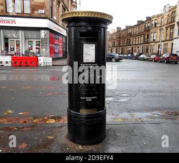 This Royal Mail post box, in Glasgow, has been painted black and gold to celebrate Black History month, October 2020. It is a tribute to Walter Tull, who was the 1st black officer in the regular British Army. He was also signed up to play for Rangers football team before being killed in action, in France, on the 25th March 1918. ALAN WYLIE/ALAMY© Stock Photo