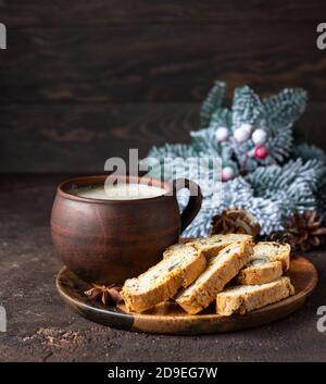 Italian homemade biscotti or cantuccini with almond and raisin and a cup of coffee on wooden plate. Traditional double baked cookies. Christmas or New Stock Photo