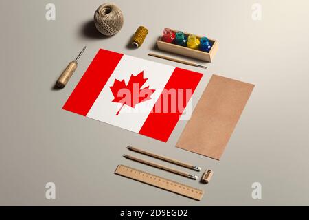 Canada calligraphy concept, accessories and tools for beautiful handwriting, pencils, pens, ink, brush, craft paper and cardboard crafting on wooden t Stock Photo