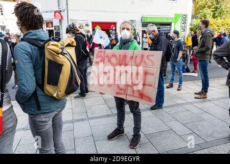 Gottingen, Germany. Autumn 2020. Fridays for future. Young man holding up sign at demonstration against climate change. Stock Photo