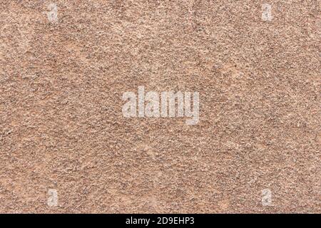The surface of a rough uneven wall, plastered with fine marble chips. Stock Photo
