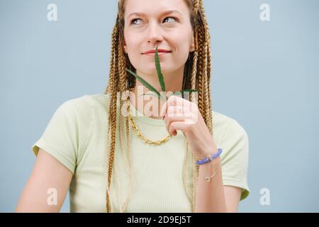 Young female model with braided blonde hair, big green eyes and
