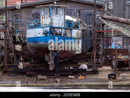 Freest, Germany. 05th Nov, 2020. A man works on an older fishing cutter at the Freest shipyard. Credit: Jens Büttner/dpa-Zentralbild/dpa/Alamy Live News Stock Photo