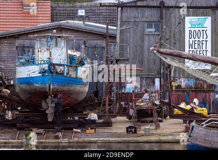 Freest, Germany. 05th Nov, 2020. A man works on an older fishing cutter at the Freest shipyard. Credit: Jens Büttner/dpa-Zentralbild/dpa/Alamy Live News Stock Photo