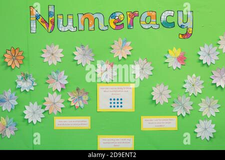 A classroom wall display with the word numeracy formed of cut out letters with flowers, work and explanations in a south west London primary school. 26 February 2015. Photo: Neil Turner Stock Photo