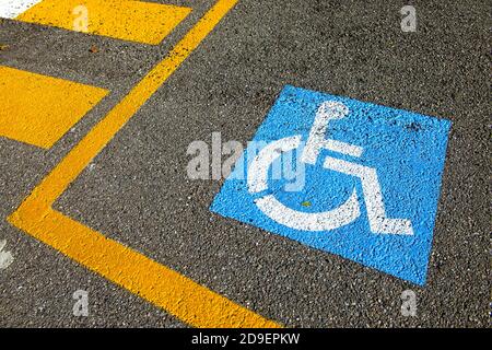 Disability sign on the asphalt for reserved parking spot. Stock Photo