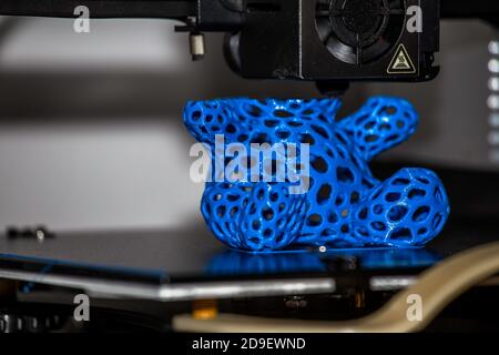 Modern 3D printer printing figure close-up macro. Stock Photo