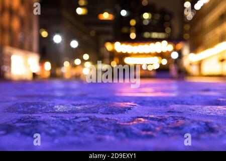 Blurred backdrop image of cobblestone street and lights from New York City. Stock Photo