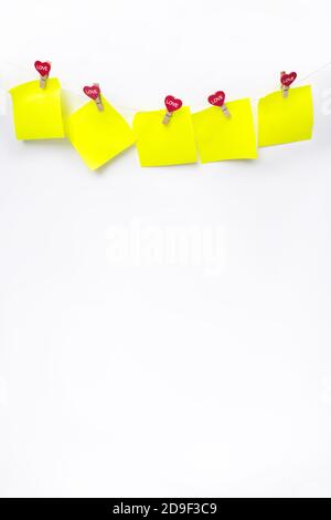 Red hearts with Blank Notes on rope with clothespins, on a white background. Place for text, copy space Stock Photo