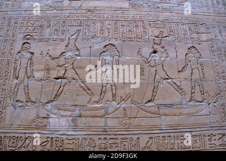 The king stands on land on the left, with two ships in front of him, in which are Horus and an attendant; Horus holds the hippopotamus with a chain an Stock Photo